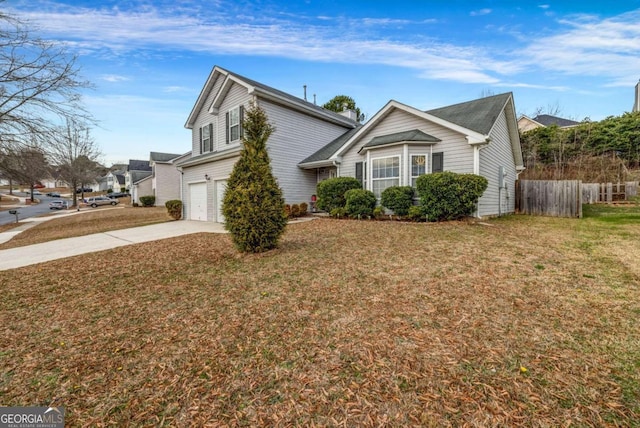 view of front facade featuring driveway, an attached garage, fence, and a front yard