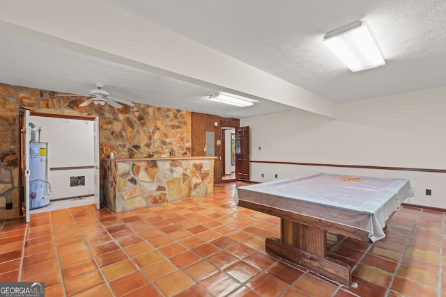 game room with gas water heater, pool table, a textured ceiling, tile patterned flooring, and electric panel