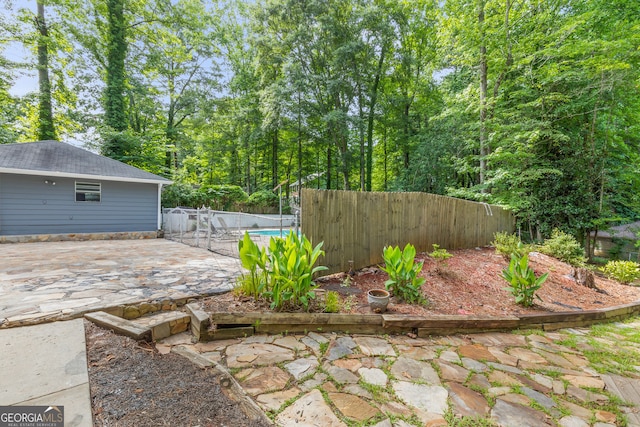 view of yard with a patio area, a fenced backyard, and a fenced in pool