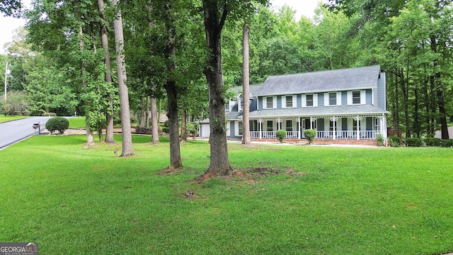 view of front of house featuring covered porch and a front yard