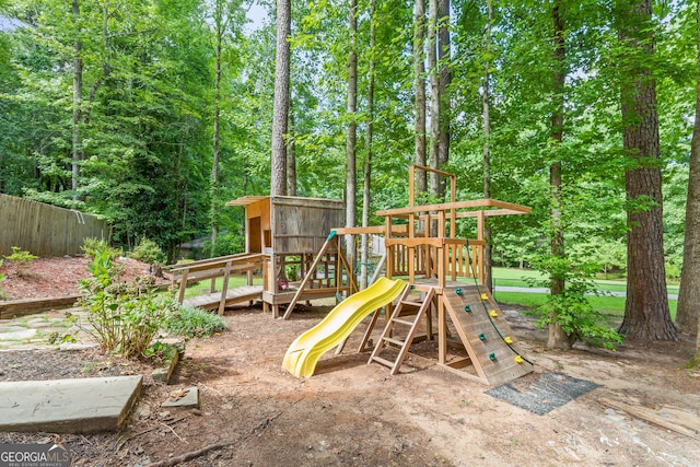 view of jungle gym featuring fence