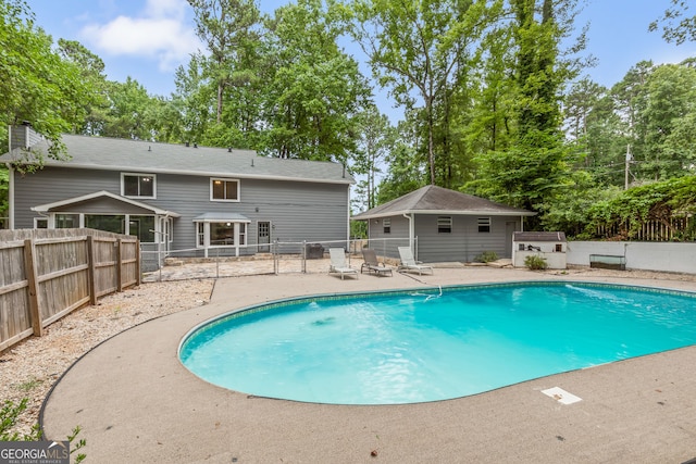 view of swimming pool featuring fence, a fenced in pool, and a patio