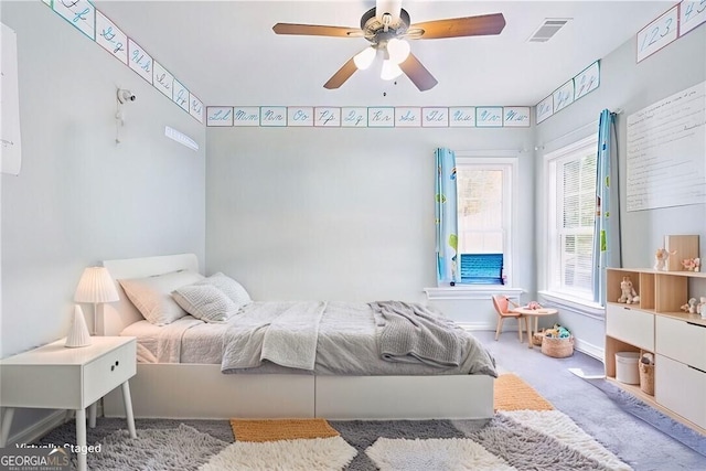 bedroom with carpet floors, ceiling fan, and visible vents