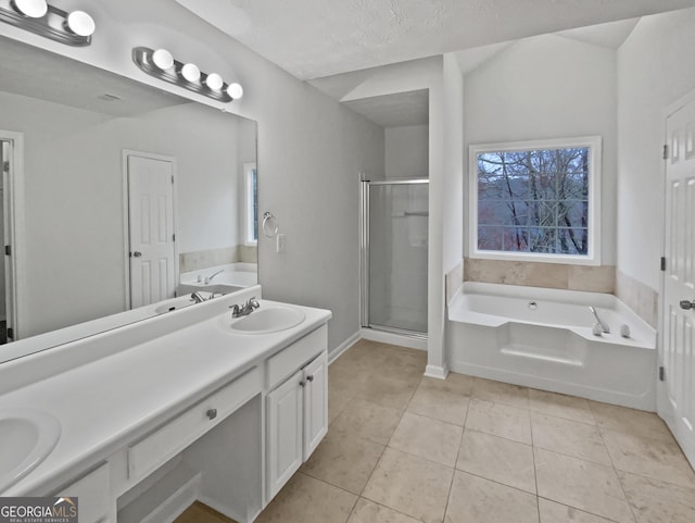 full bathroom featuring a garden tub, double vanity, a sink, a shower stall, and tile patterned flooring