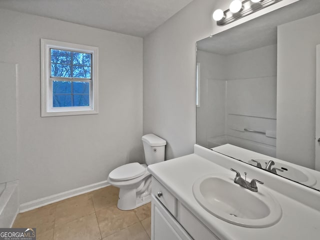 bathroom with toilet, tile patterned flooring, vanity, and baseboards