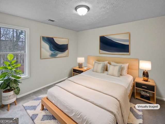 bedroom with carpet, multiple windows, and baseboards