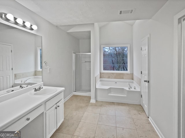 full bathroom featuring tile patterned flooring, vanity, visible vents, a shower stall, and a bath