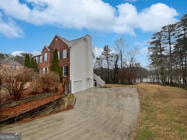 view of side of property with a garage and driveway