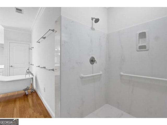 bathroom featuring walk in shower, wood finished floors, visible vents, and crown molding