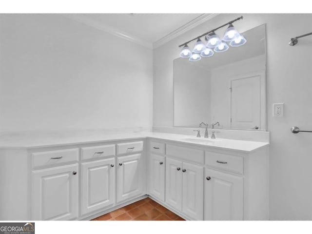 bathroom with tile patterned flooring, crown molding, and vanity