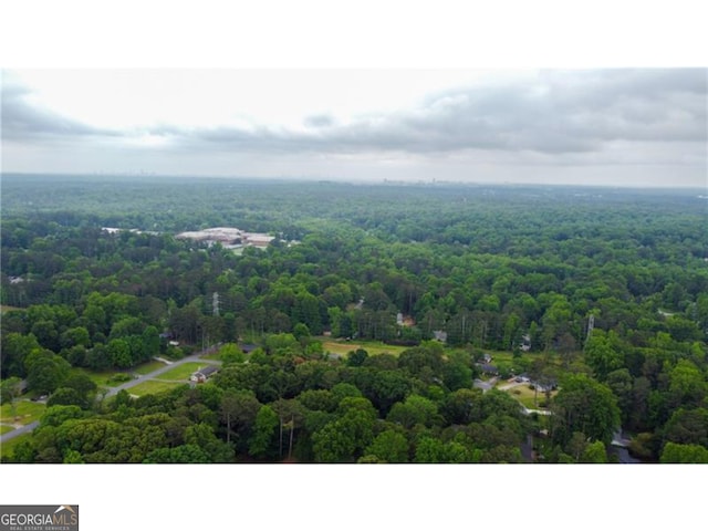 birds eye view of property featuring a forest view