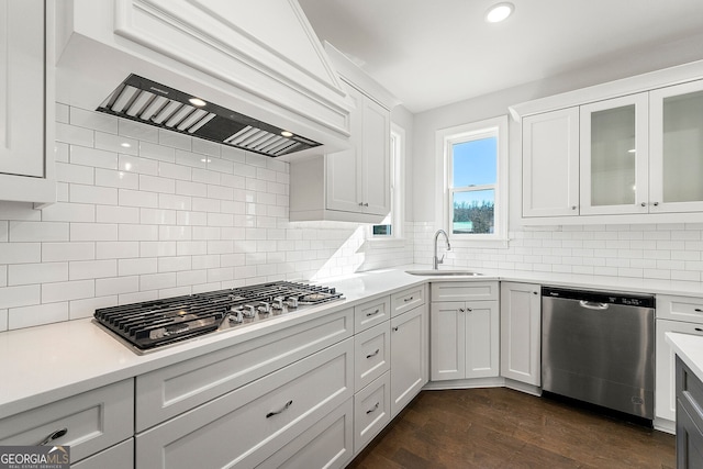 1295 Stonewood Field Rd, Watkinsville, GA 30677 - kitchen with stainless steel appliances, custom exhaust hood, light countertops, backsplash, and white cabinetry