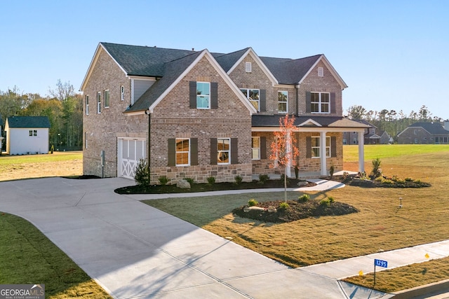 view of front facade with driveway, a front lawn, and brick siding