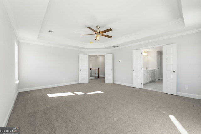 1295 Stonewood Field Rd, Watkinsville, GA 30677 - unfurnished bedroom featuring a tray ceiling, ornamental molding, carpet floors, and ensuite bathroom