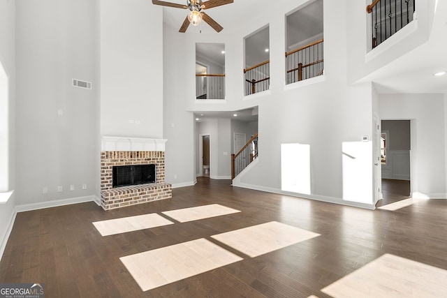 1295 Stonewood Field Rd, Watkinsville, GA 30677 - unfurnished living room with ceiling fan, stairs, a high ceiling, wood finished floors, and recessed lighting