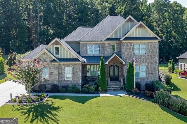 craftsman-style home with stone siding, a front lawn, and board and batten siding