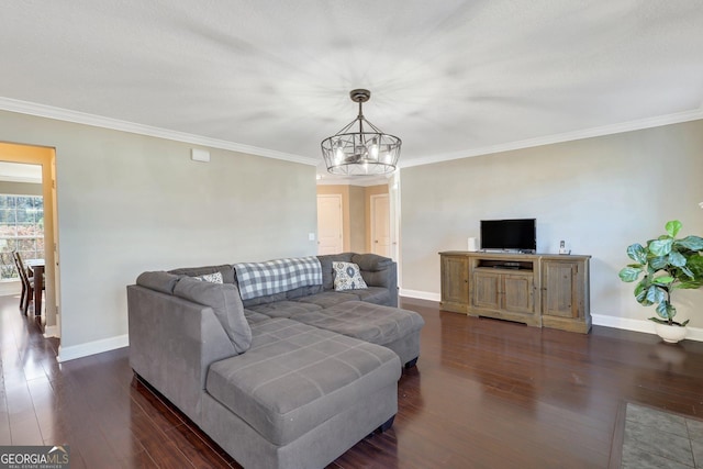 living room featuring dark wood-style floors, ornamental molding, baseboards, and an inviting chandelier