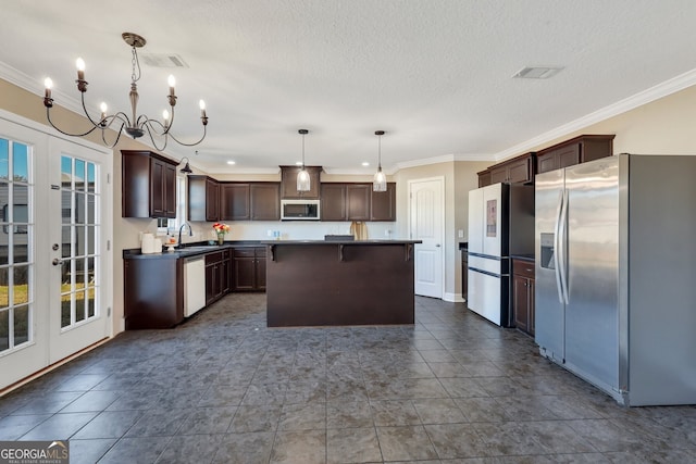 kitchen with a center island, french doors, decorative light fixtures, stainless steel appliances, and a sink