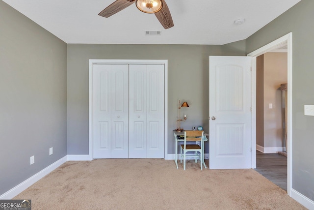 unfurnished bedroom featuring carpet floors, a closet, visible vents, ceiling fan, and baseboards