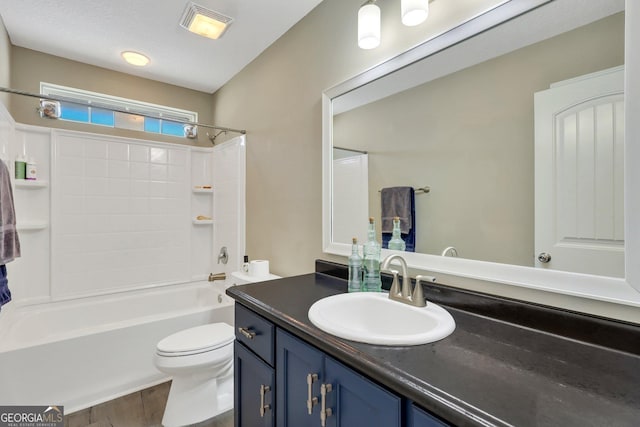 bathroom featuring visible vents, toilet, vanity, shower / tub combination, and wood finished floors