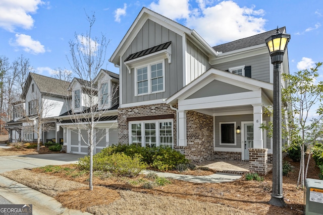 view of front of house with driveway, brick siding, and board and batten siding