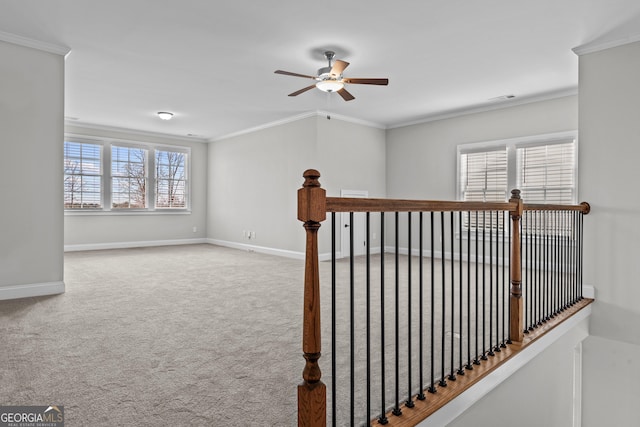 hall with carpet floors, visible vents, baseboards, and crown molding