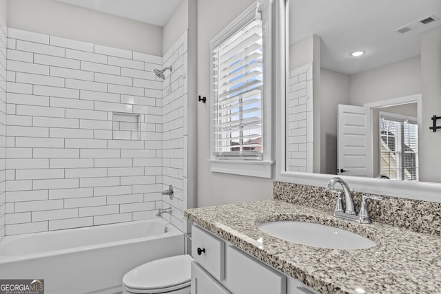 full bath featuring shower / bath combination, visible vents, vanity, and toilet