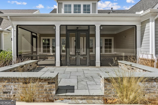 doorway to property featuring a shingled roof