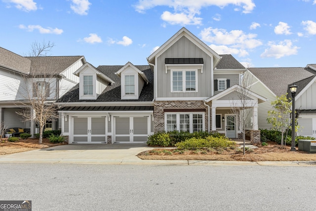 view of front of property featuring brick siding, central AC unit, board and batten siding, a garage, and driveway