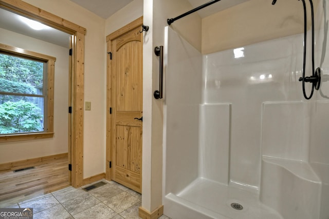 658 Dover Falls Trl, Ellijay, GA 30540 - unfurnished bedroom featuring lofted ceiling, baseboards, light wood-type flooring, and visible vents