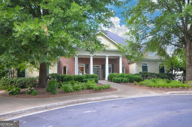 greek revival house with brick siding