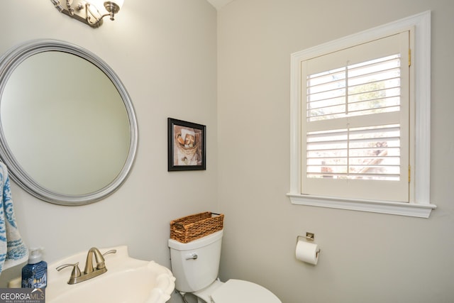 bathroom with toilet and a sink