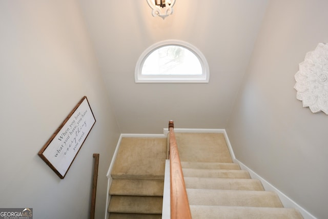 staircase featuring carpet floors and baseboards