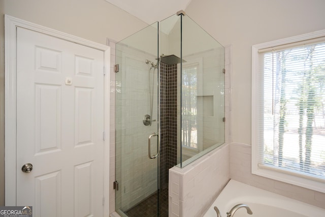 bathroom with a garden tub and a shower stall