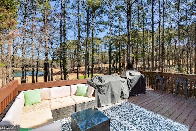 wooden deck featuring an outdoor living space and grilling area