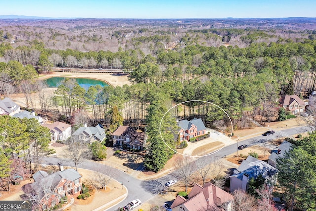 drone / aerial view with a water view and a residential view