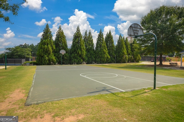 view of sport court with community basketball court, a lawn, and fence