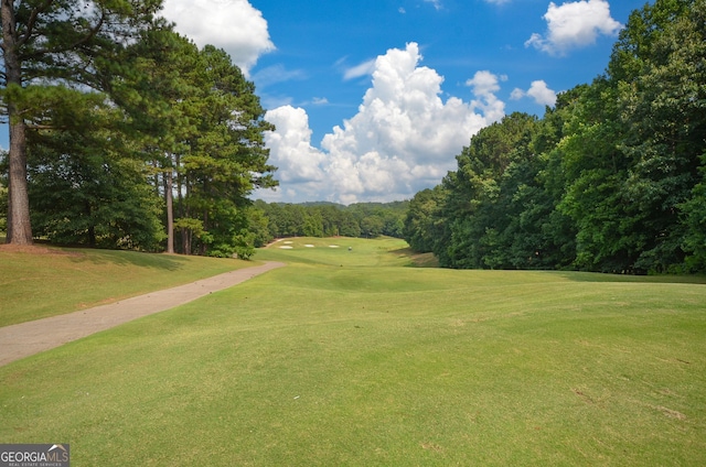 surrounding community with a lawn and golf course view