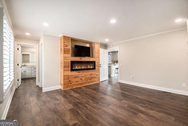 unfurnished living room featuring a fireplace, baseboards, dark wood finished floors, and recessed lighting