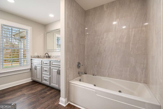 full bathroom featuring recessed lighting, baseboards, wood finished floors, and vanity