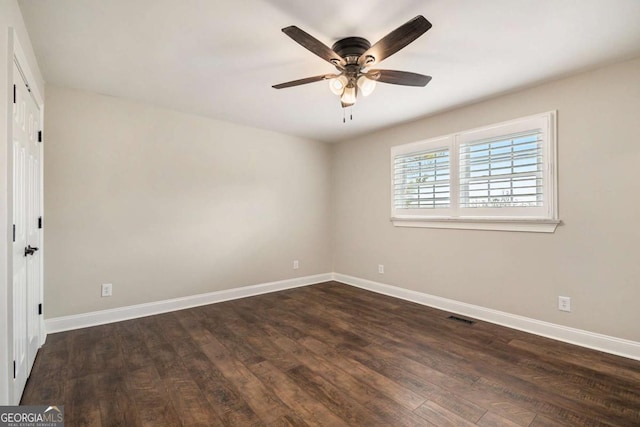 unfurnished bedroom with dark wood-style floors, baseboards, visible vents, and ceiling fan