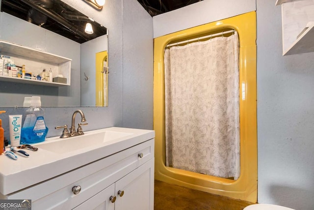 bathroom with curtained shower and vanity