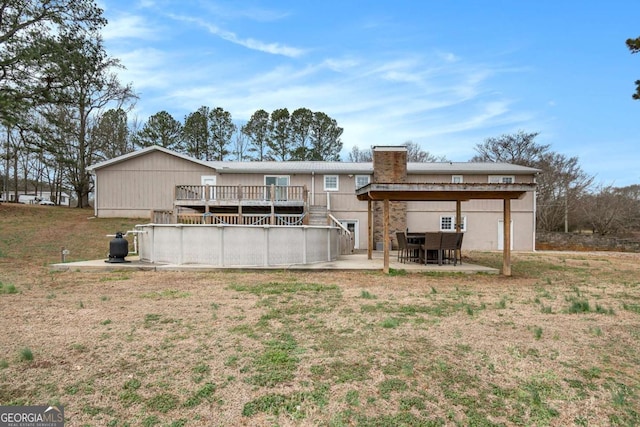 back of property with a patio and a wooden deck