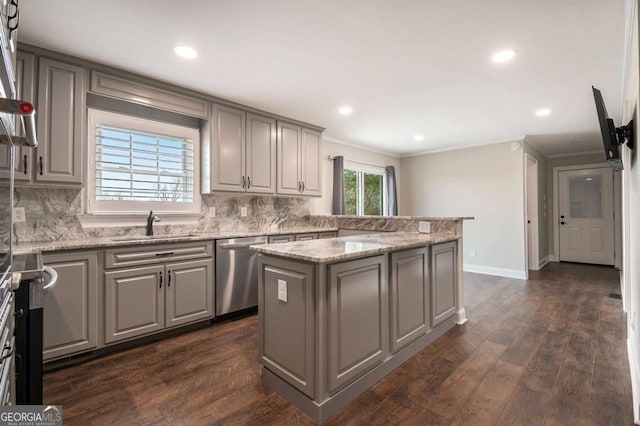 kitchen with dark wood-type flooring, a center island, light stone countertops, stainless steel dishwasher, and a sink