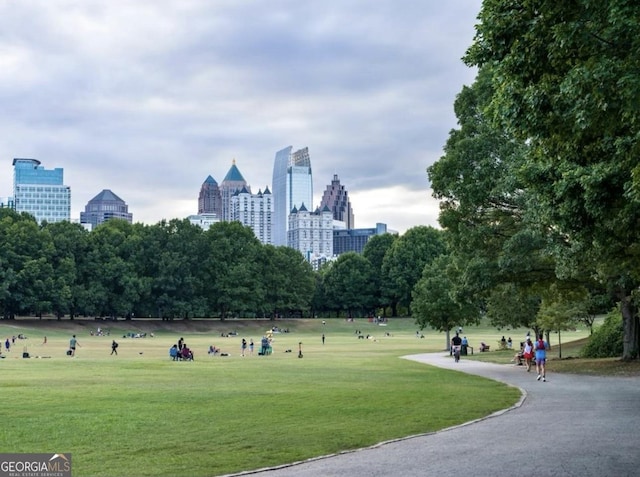 view of community featuring a city view and a lawn