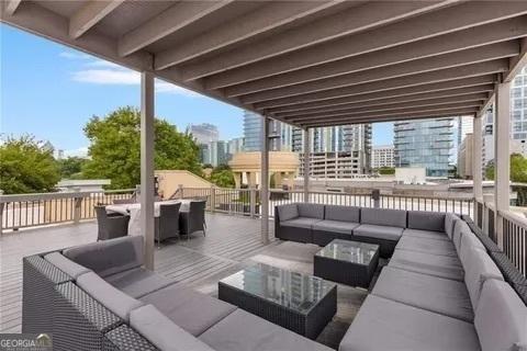 view of patio featuring a view of city, outdoor lounge area, and outdoor dining space