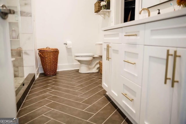 full bath with a stall shower, tile patterned flooring, toilet, and baseboards