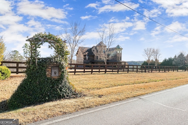 view of yard with a rural view and fence