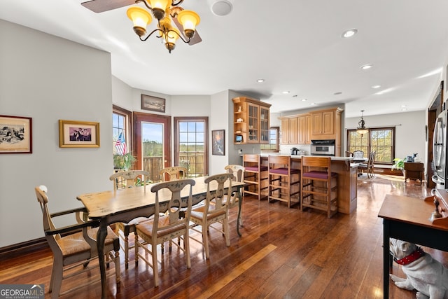 dining room with dark wood-type flooring, recessed lighting, a chandelier, and baseboards