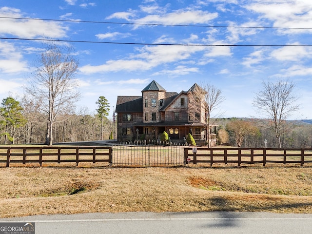 view of front of home with a rural view and a fenced front yard